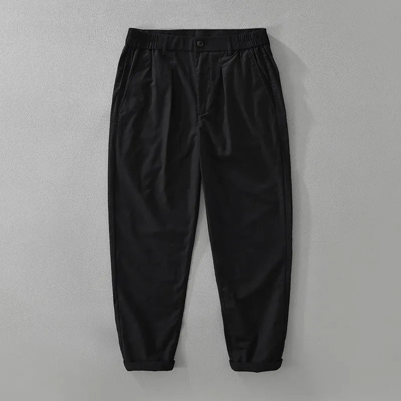Man wearing loose straight-leg cotton linen trousers in a raw jute colour, showcasing the Japanese retro casual style.