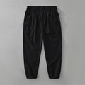 Man wearing loose straight-leg cotton linen trousers in a raw jute colour, showcasing the Japanese retro casual style.