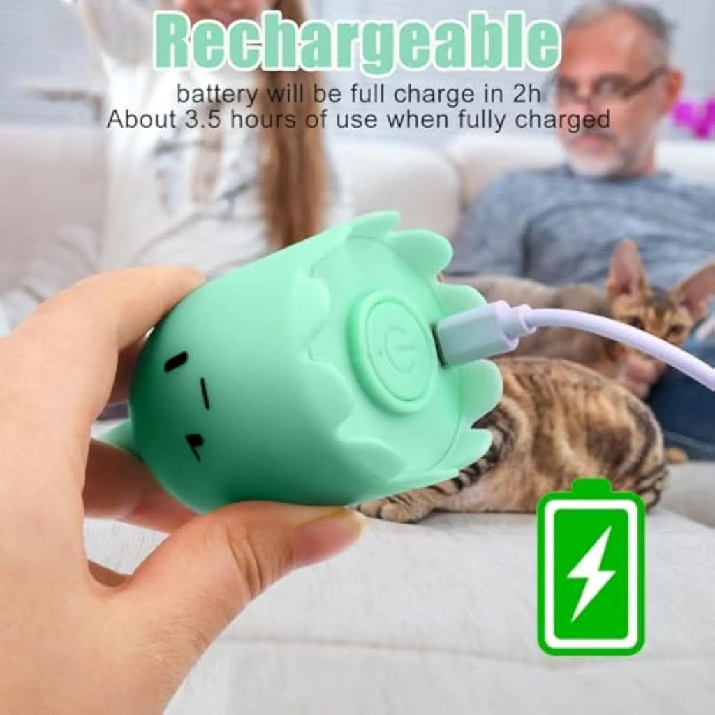 Green rechargeable automatic electronic cat wand toy with swinging silicone tail on a wooden floor