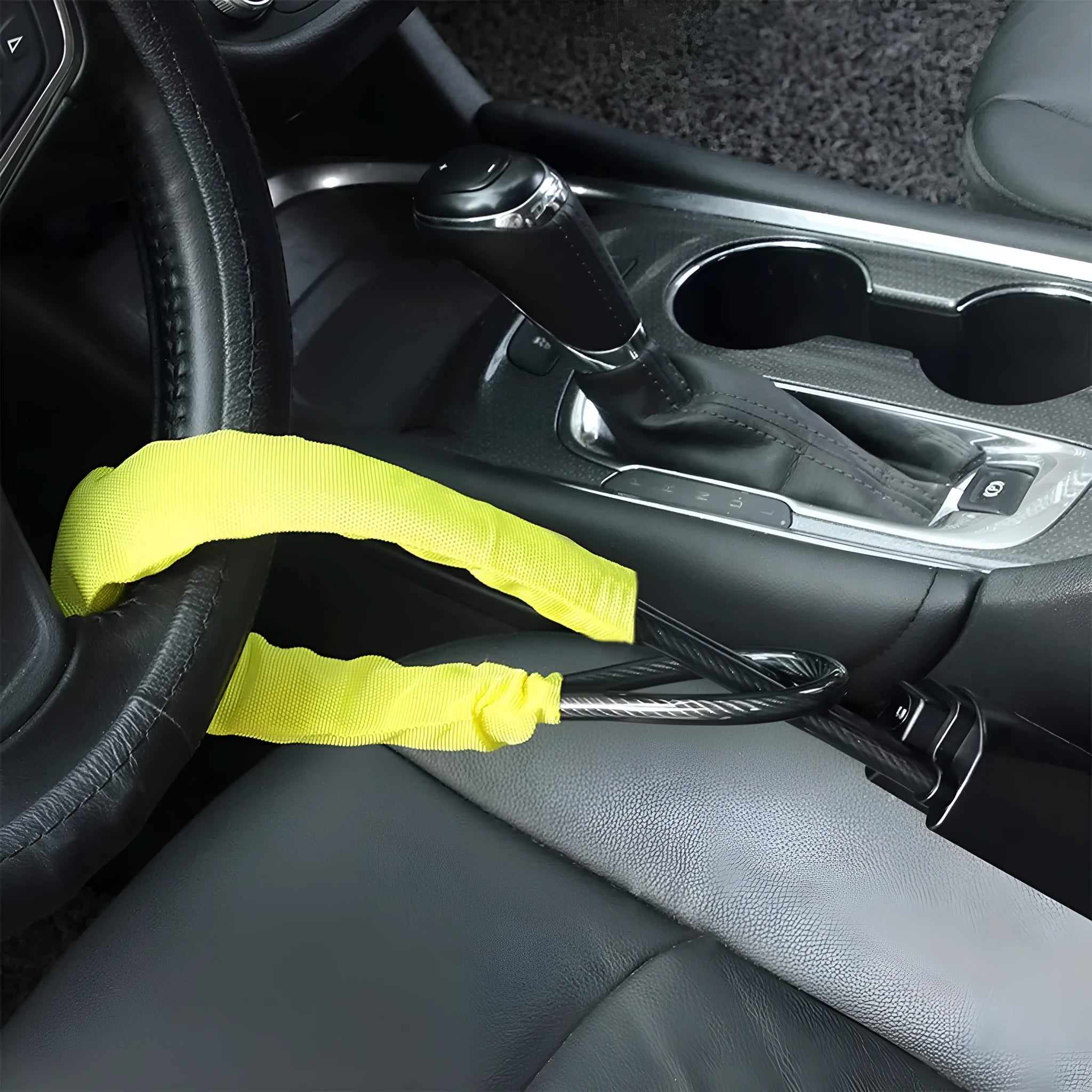 Red iron car steering wheel lock with wire rope, shown on a GM vehicle steering wheel.