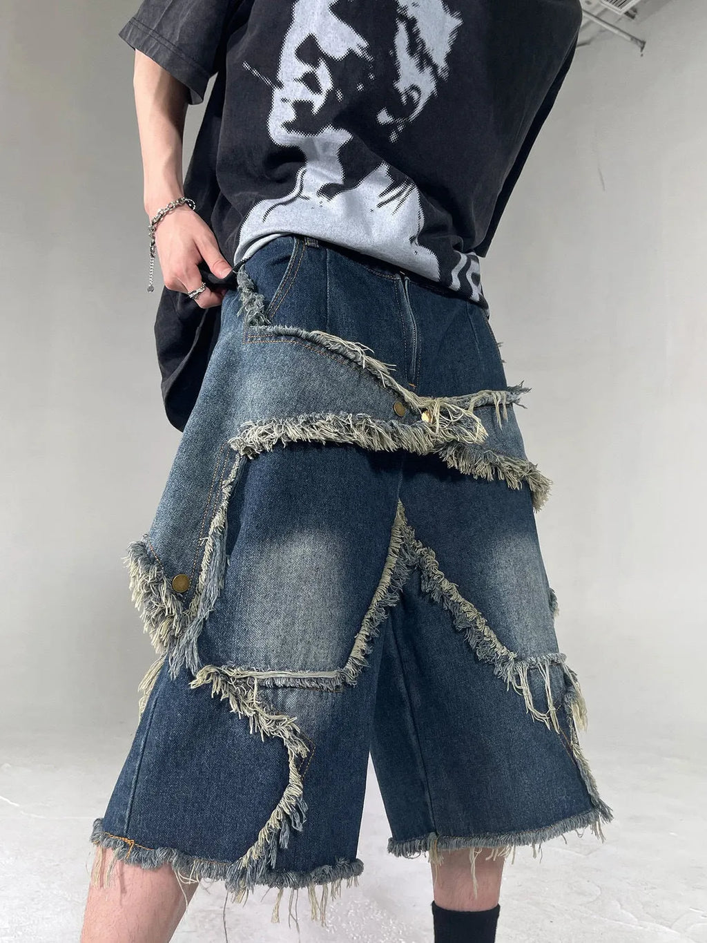 Blue retro-style men's denim shorts with a frayed five-pointed star design and a loose fit.