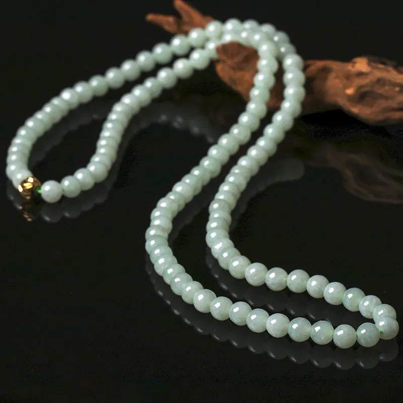 Women's adjustable jade bead necklace with round white green beads on a chain.