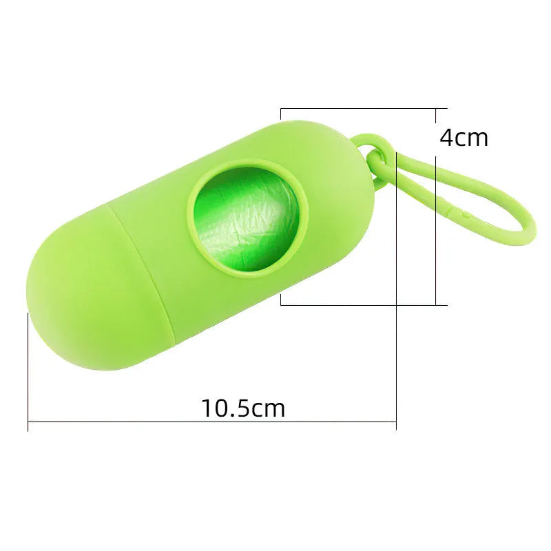 A compact black dog poo bag holder with a side hook and Velcro strap, shown attached to a dog lead.