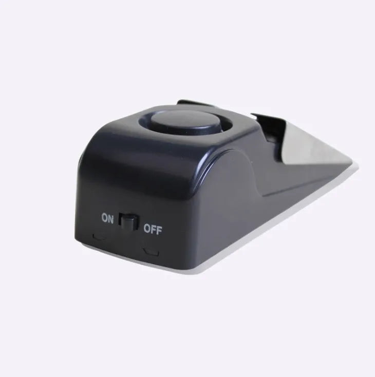 Portable wedge-shaped door stop alarm with stainless steel cover and 120 dB siren for home and travel security
