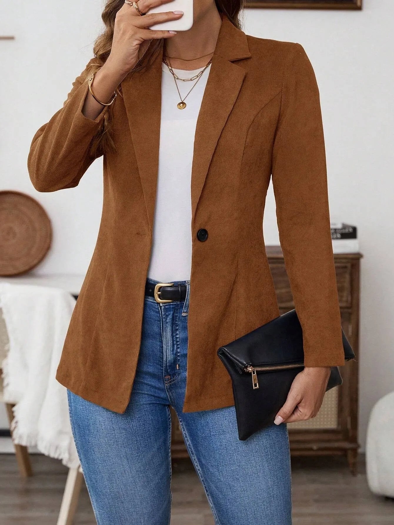Brown men's single-breasted lapel suit coat on a hanger.