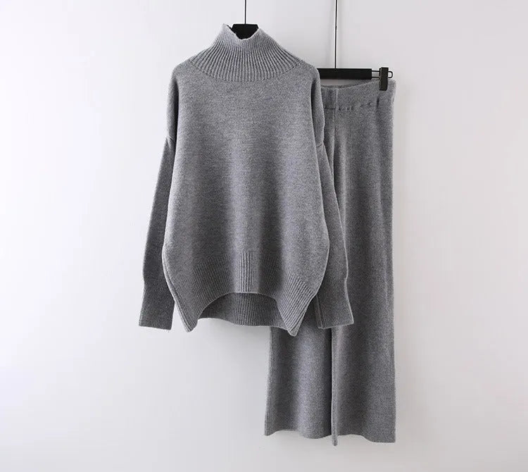 Women's beige acrylic fibre sweater and wide-leg trousers two-piece set on a hanger.