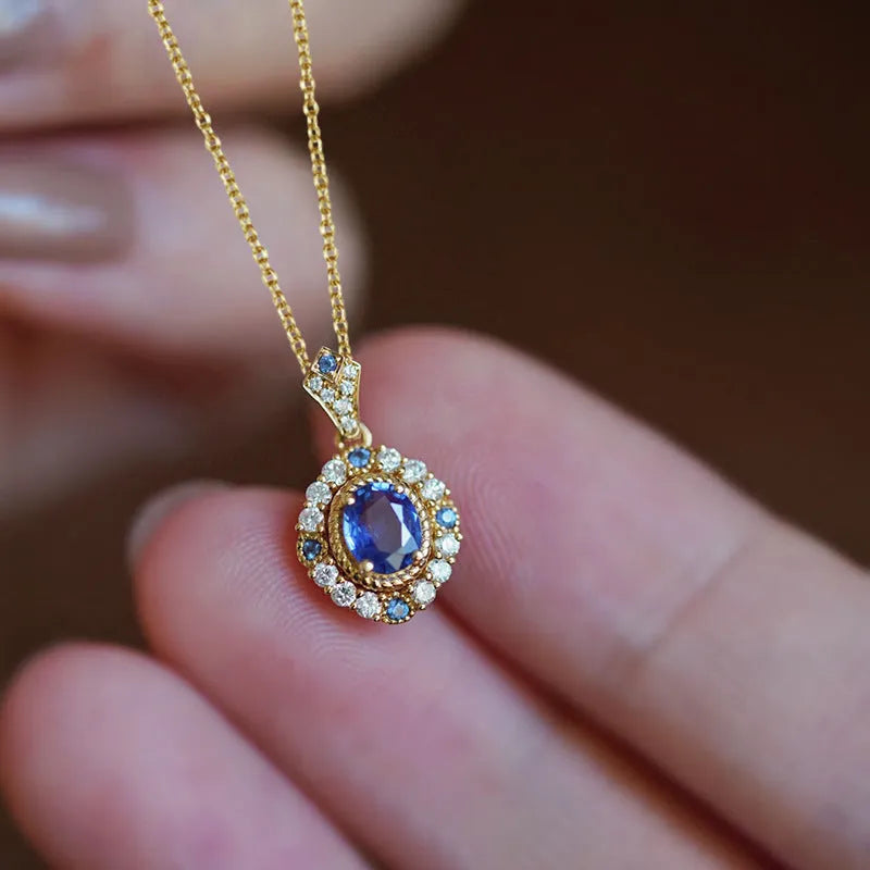 Golden copper necklace with a mixed gemstone inlaid pendant on a box chain.