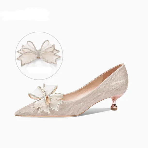 Champagne coloured sequinned pointed toe stiletto high heel pump on a white background.