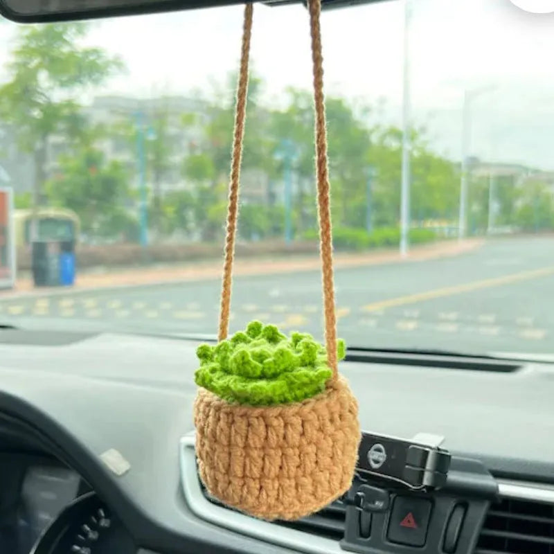 Green and white knitted wool car plant decoration with 8cm base and hanging rope.