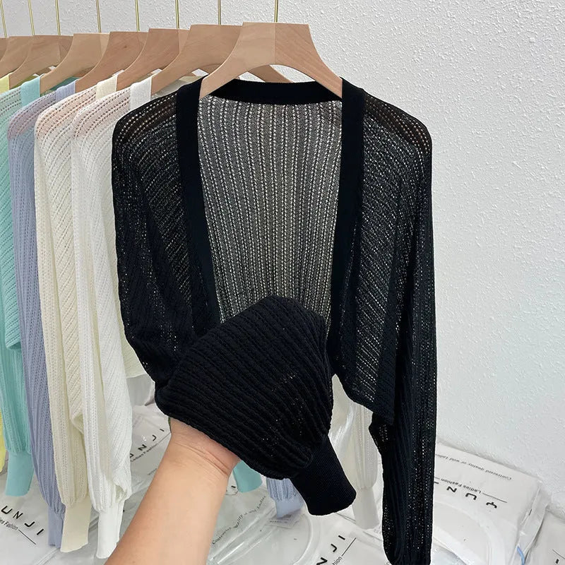 Thin polyester linen blouse with hollow out pattern and long lantern sleeves in apricot colour.