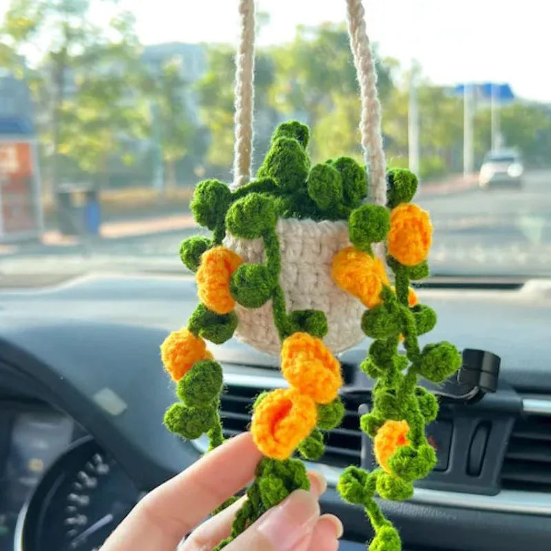Green and white knitted wool car plant decoration with 8cm base and hanging rope.