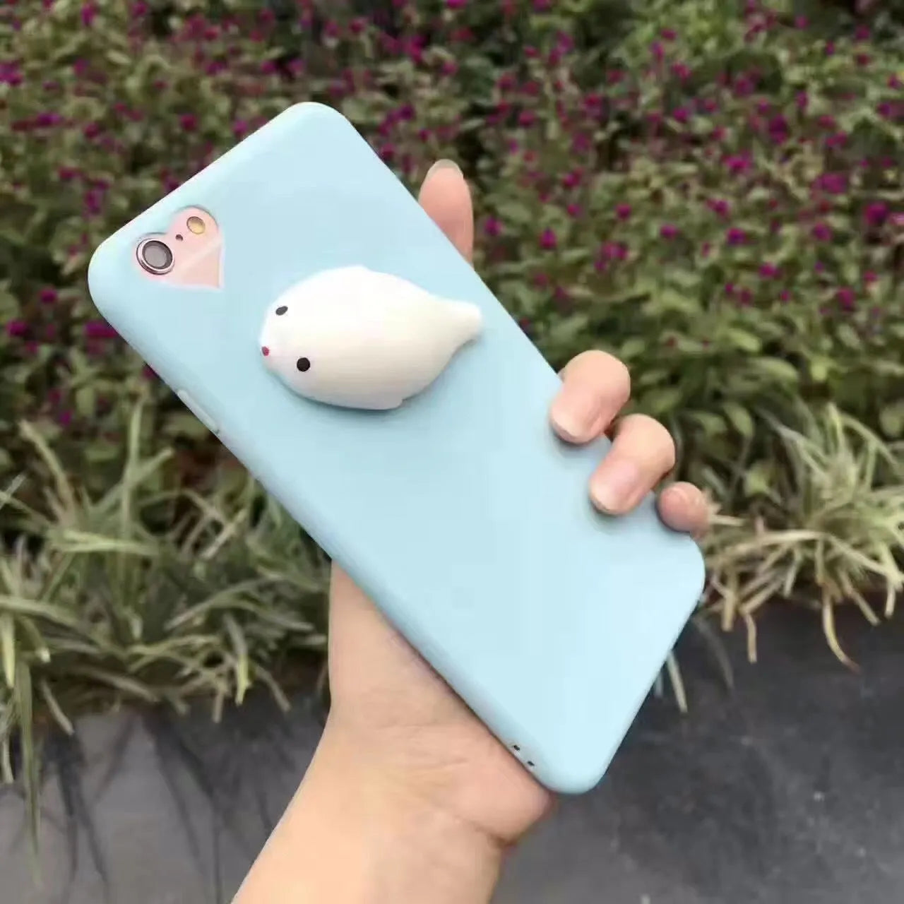 Soft pink TPU silicone iPhone case with a raised 3D cartoon cat design on the back.