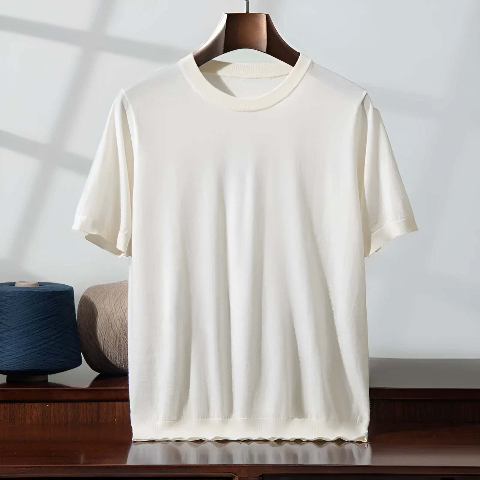 Man wearing a loose thin knitted short sleeve shirt in a casual setting