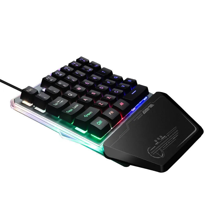 Black robotic one-handed mechanical keyboard with RGB backlit keys on a desk.