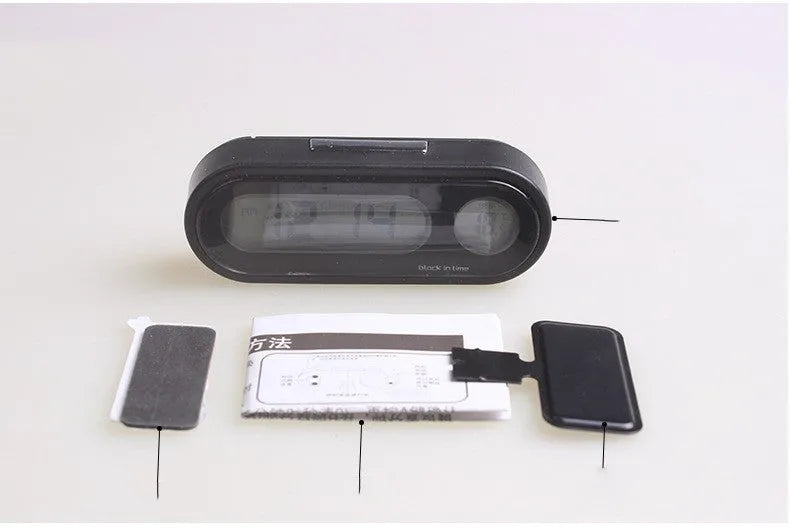 Black digital car dashboard clock and thermometer with LED display on an adjustable mounting bracket.