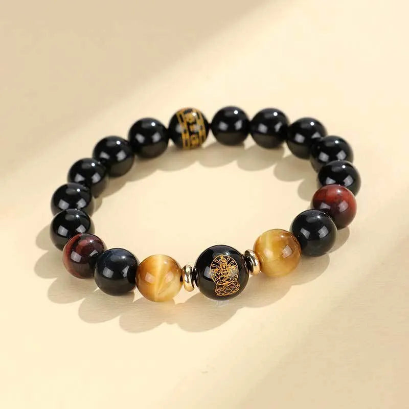 Handmade black agate bracelet with zodiac animal charms and gold tiger eye beads on wrist