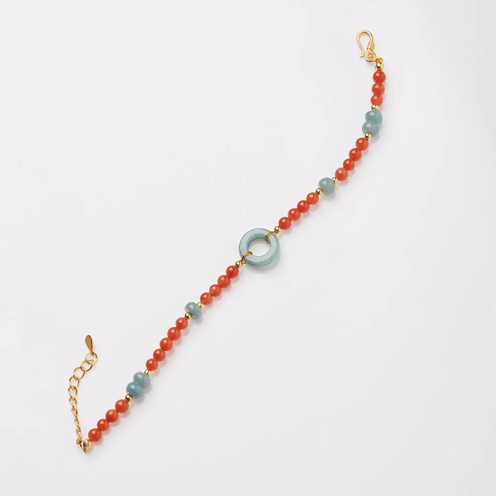Close-up of a women's south red agate bracelet with geometric beads and a safety buckle clasp on a wrist.