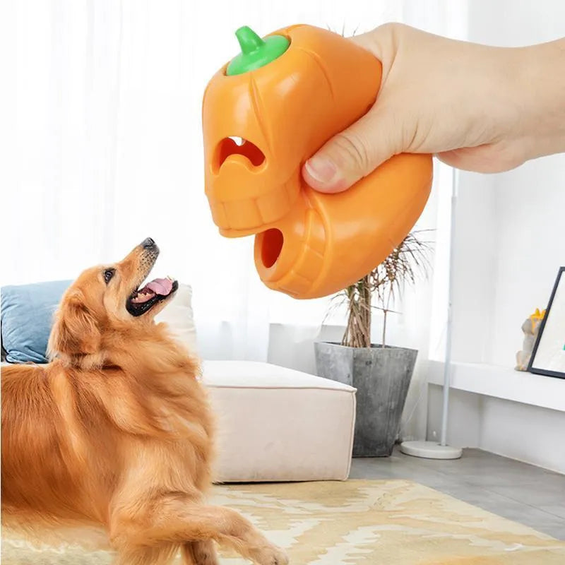 Yellow pumpkin-shaped tough TPR chew toy for dogs on a white background.