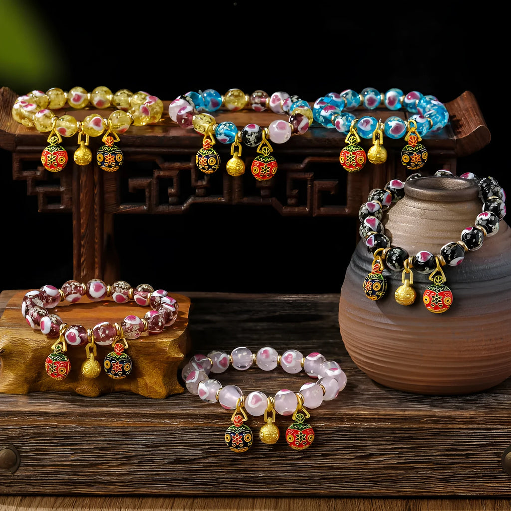 Handmade glass bracelet with swallowing gold beast design and cherry blossom heart in six colours.