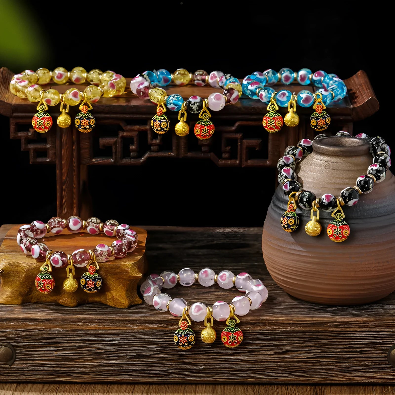 Handmade glass bracelet with swallowing gold beast design and cherry blossom heart in six colours.