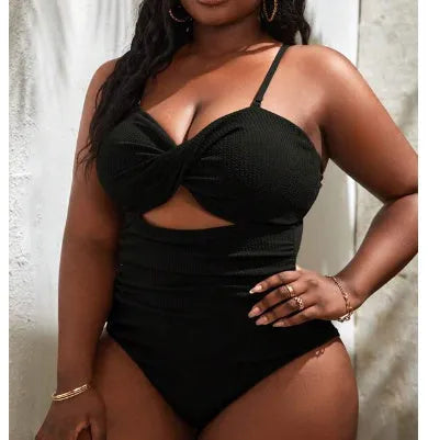 Black plus size one-piece swimsuit for women, sleeveless design, shown on a model.