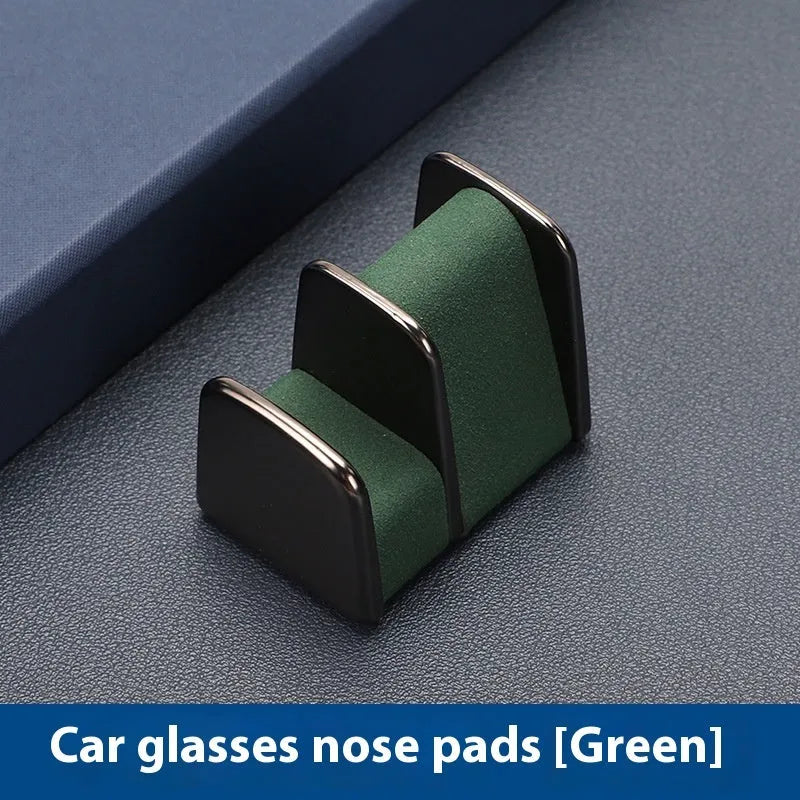 Zinc alloy and leather glasses clip for car dashboard in black, grey, green, or red.