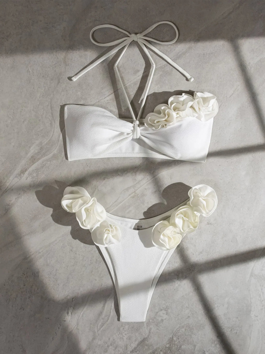 White women's halter lace-up bikini with three-dimensional floral pattern and briefs