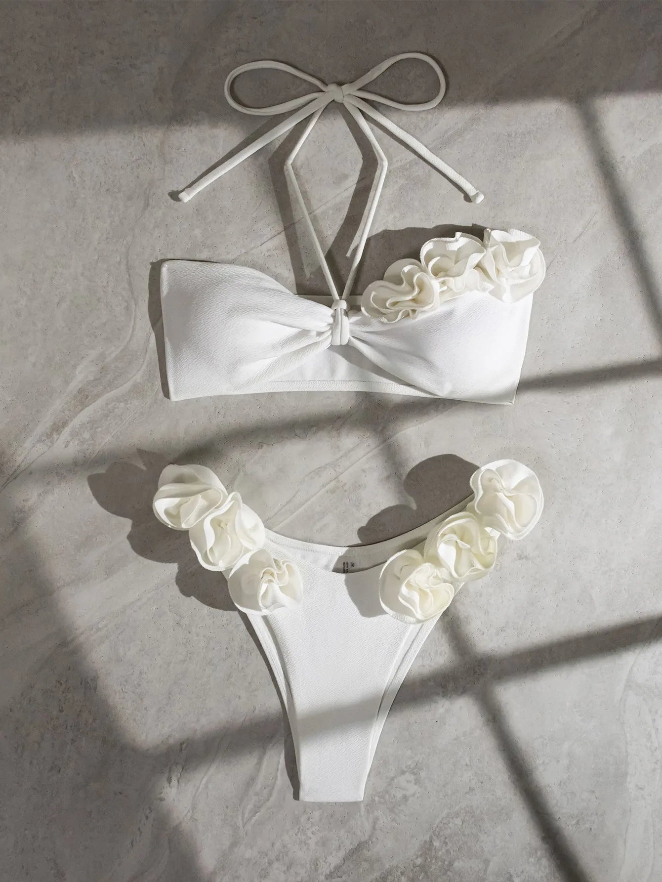White women's halter lace-up bikini with three-dimensional floral pattern and briefs