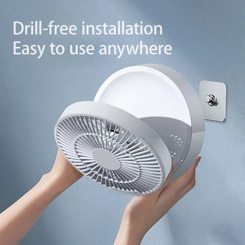 White portable folding electric fan with night light and remote control on a desk