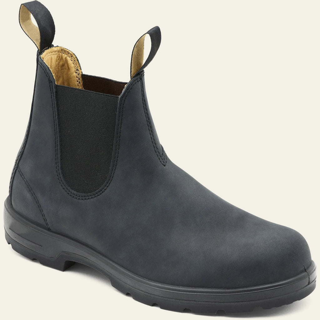 Vintage brown unisex Chelsea boots with round toe and low horseshoe heel on a wooden floor.
