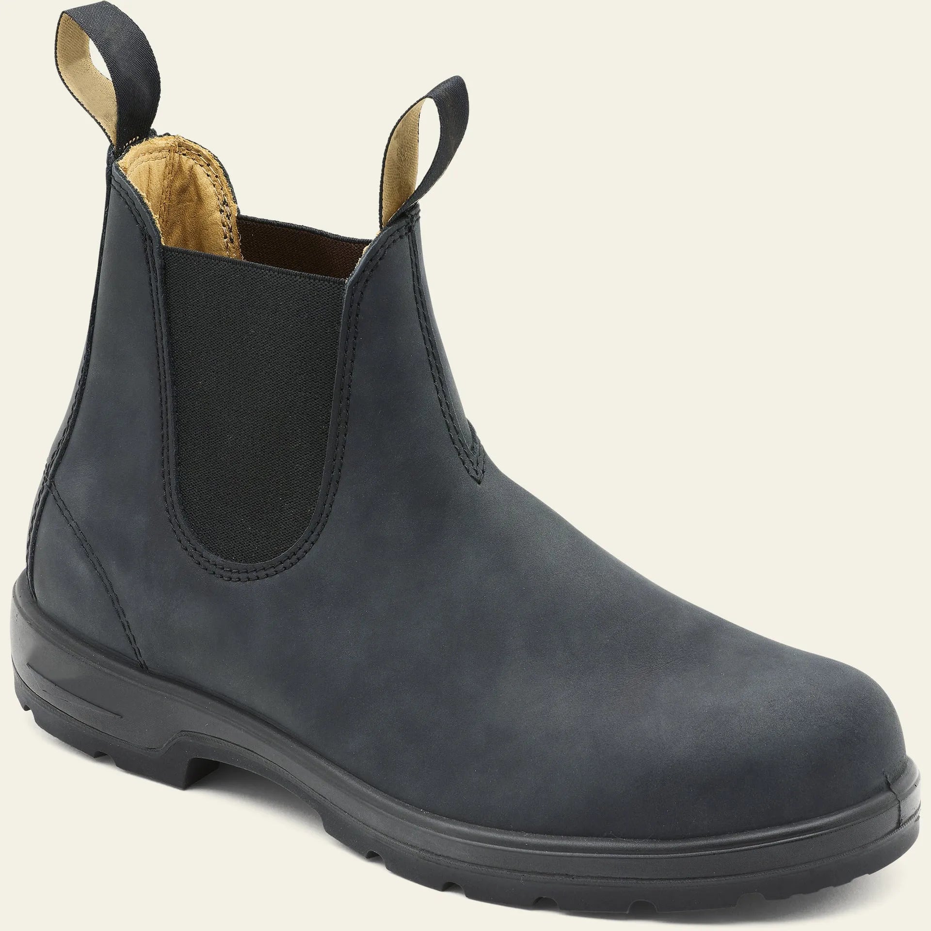 Vintage brown unisex Chelsea boots with round toe and low horseshoe heel on a wooden floor.