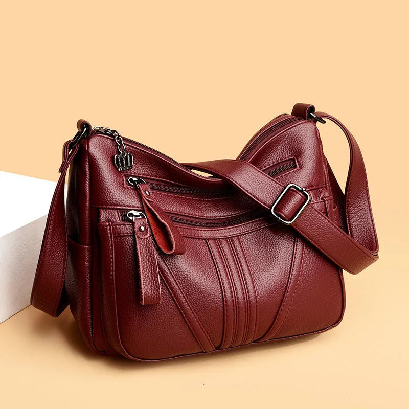 Genuine leather shoulder messenger bag in horizontal square shape with multiple internal compartments and single strap