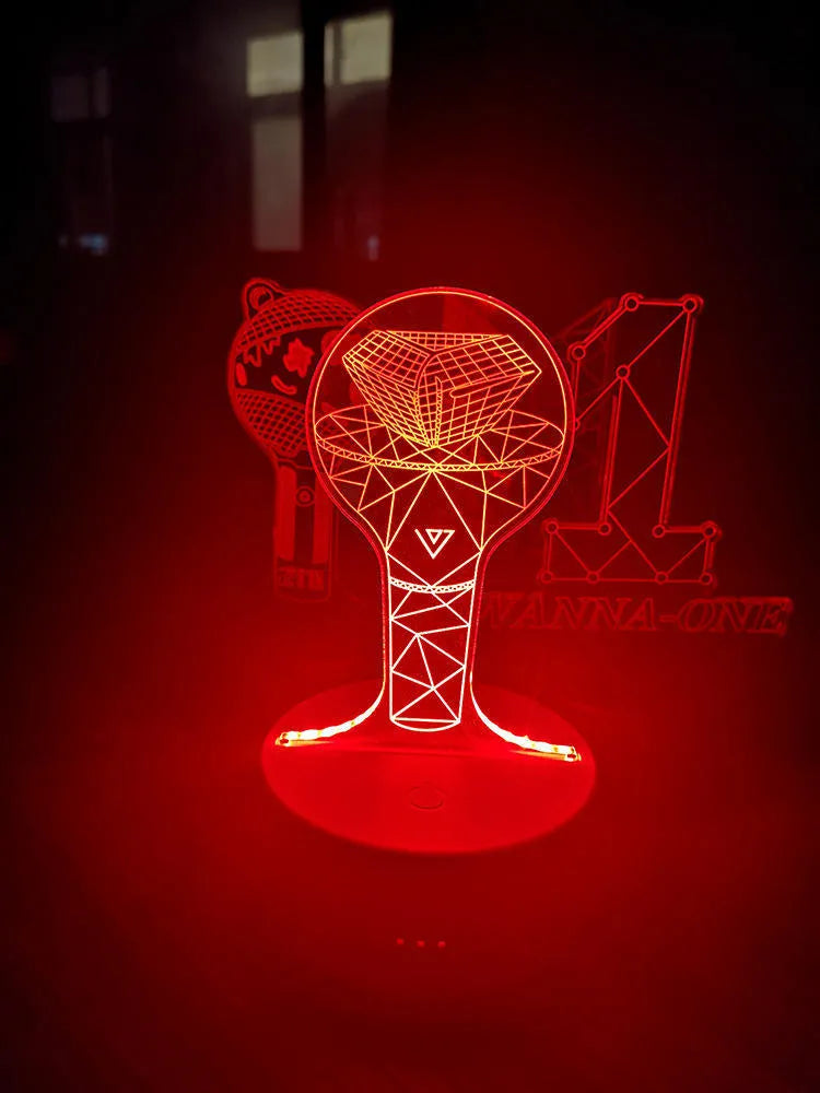 Transparent acrylic display stand showing illuminated BTS Light 101 Tower Gem collectible lamp.