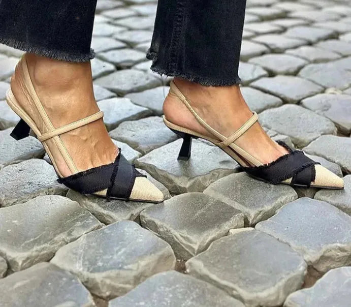 Apricot and black colour block women's stiletto heel sandals with a buckle fastening and pointed toe.