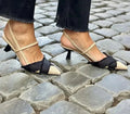 Apricot and black colour block women's stiletto heel sandals with a buckle fastening and pointed toe.