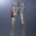 Men's slim fit vintage jeans with a washed-out colour and distressed hole patch embroidery.