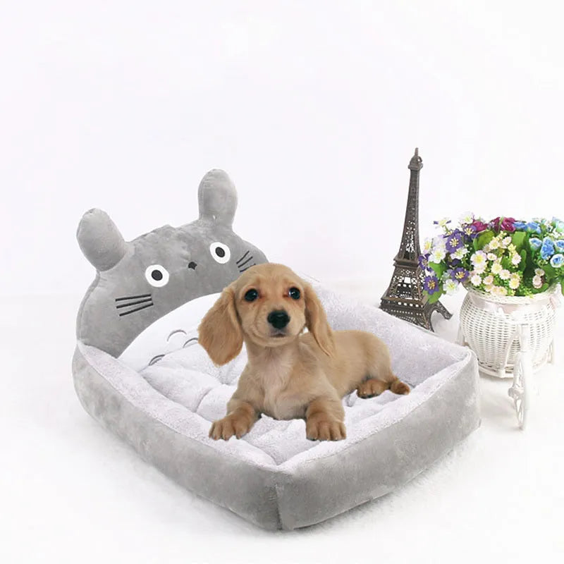 Cartoon-style plush pet bed sofa in blue, shown in small size for a dog or cat.