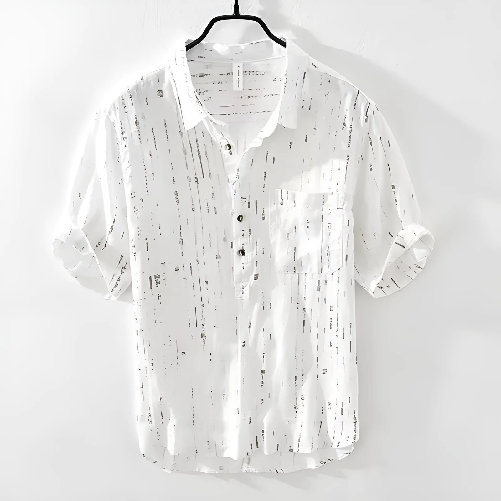 Man wearing a black loose-fit lapel polo shirt, short sleeves, casual summer style.