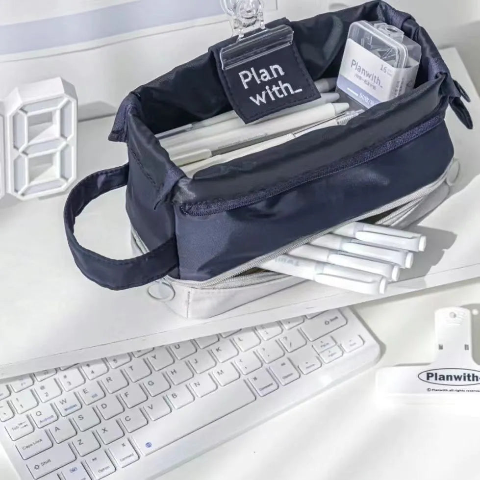 Dark blue folding double-layer pencil case made from polyester fabric, shown open to reveal internal compartments.