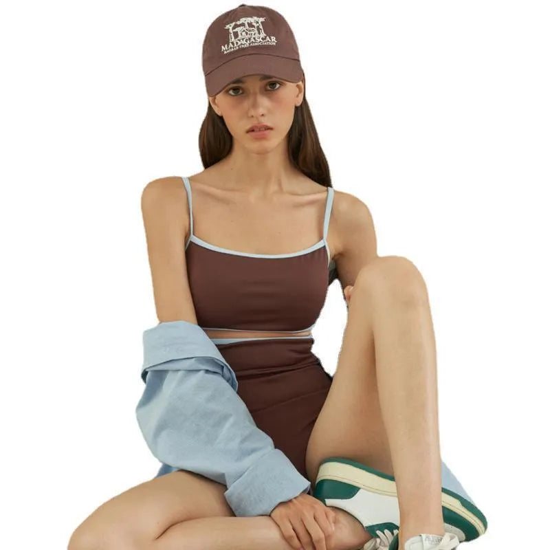 Brown women's one-piece swimsuit with a triangle pattern top on a hanger.
