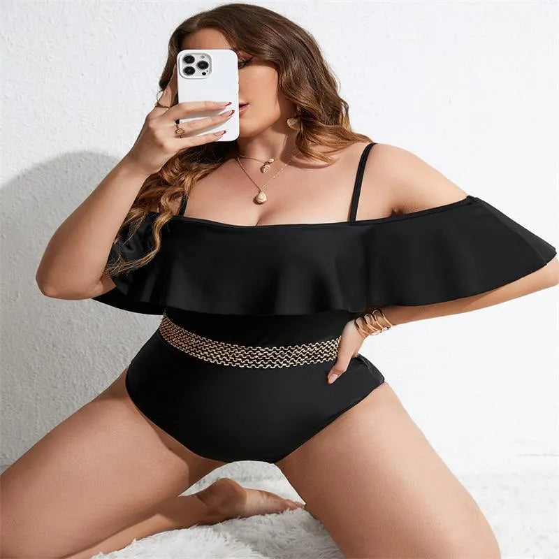Black solid colour women's one-piece swimsuit on a hanger, polyester fabric, for swimming.