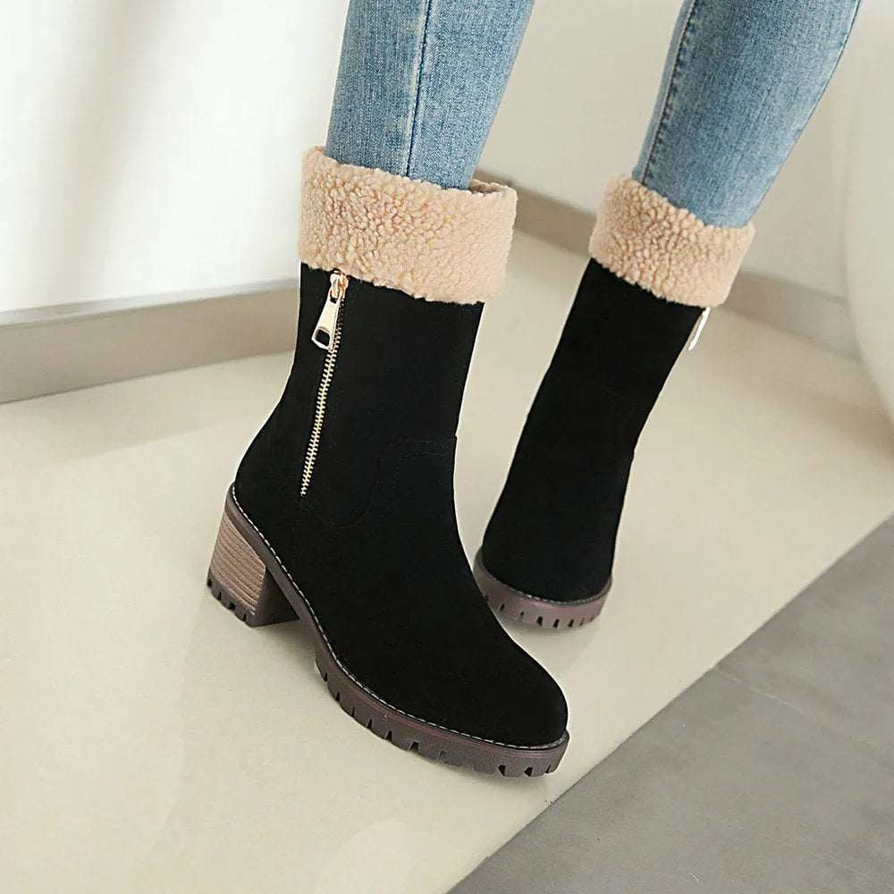 A pair of adult snow boots in black with a soft plush lining and rubber insole.