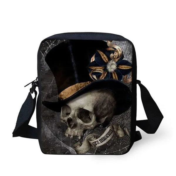 A medium-sized black children's messenger bag with a white skull print, showing double shoulder straps and a front zipper pocket.