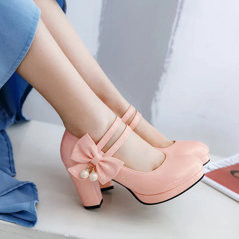 Women's red chunky heel platform shoes with round toe and buckle fastening on a rubber sole.