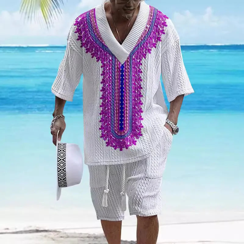 Man wearing a light blue printed drop-shoulder knitted top with matching shorts from a casual summer suit.