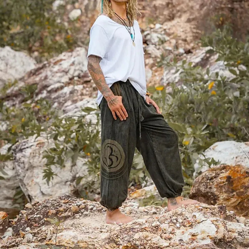 Dark green men's trousers with ethnic pattern and ankle-tied detail on polyester fabric