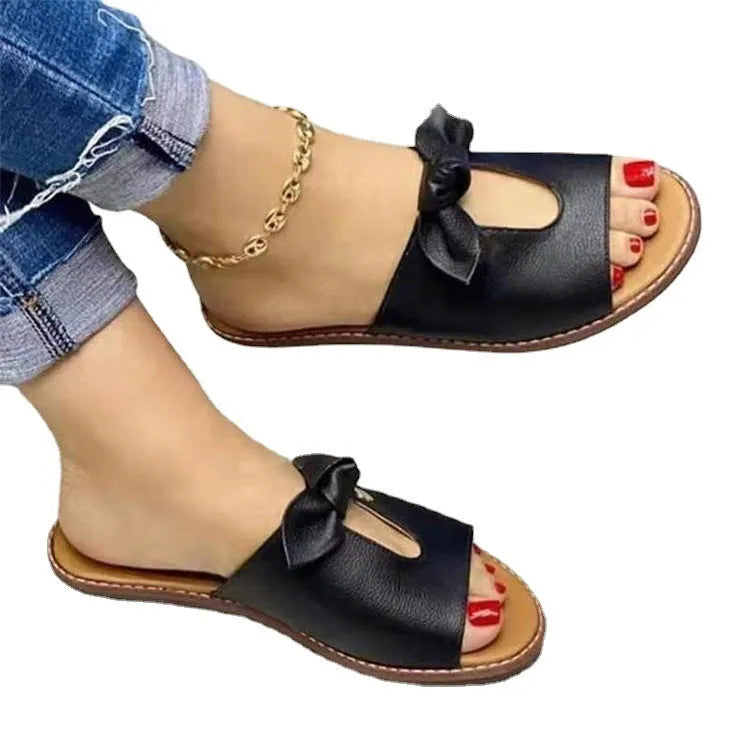 Ladies black fish mouth sandals with a bow detail on the synthetic PU upper.