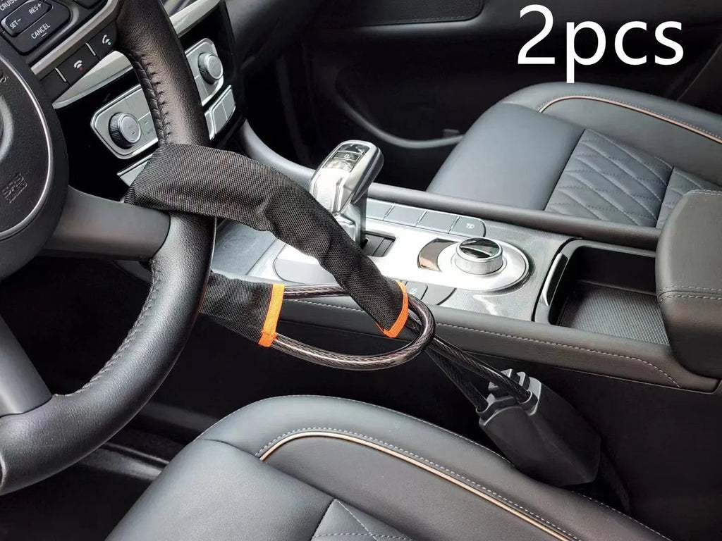 Red iron car steering wheel lock with wire rope, shown on a GM vehicle steering wheel.