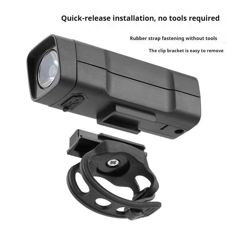 Black USB rechargeable bicycle headlight with quick-release strap mount on handlebars.