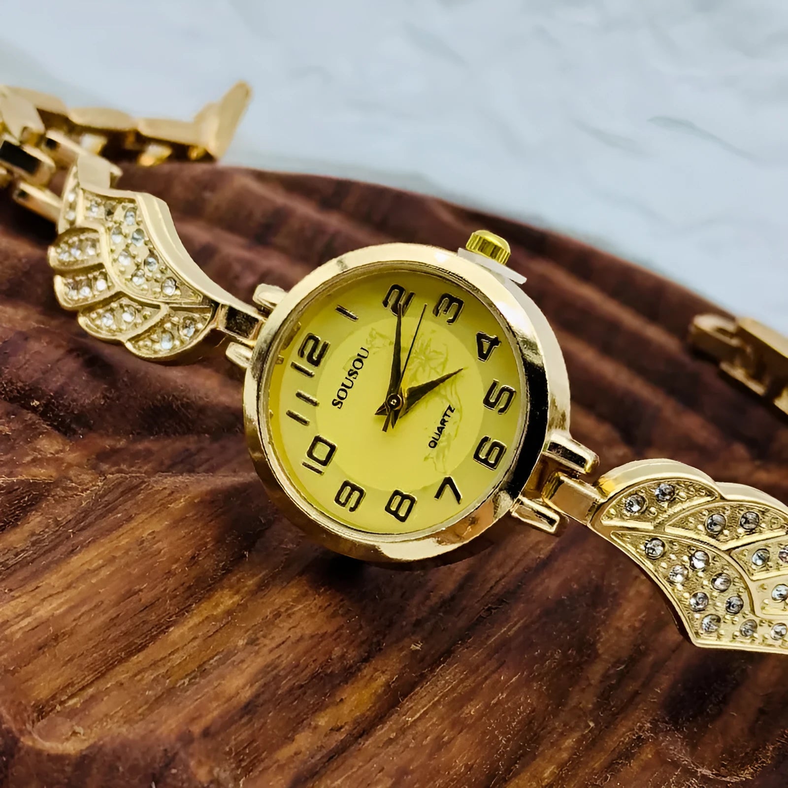 Women's round stainless steel watch with a choice of gold, golden white, or golden black dial on a steel strap with vachette clasp.